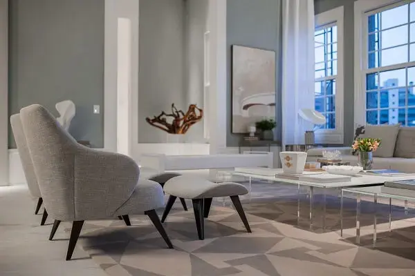 Sala neutra decorada com poltrona cinza claro com descanso de pé Sala neutra decorada com poltrona cinza claro com descanso de pé