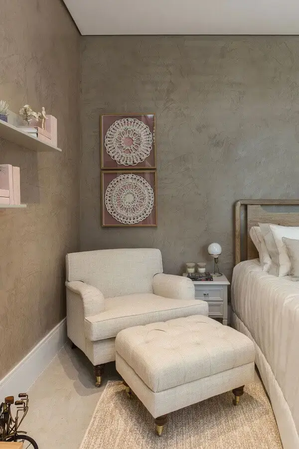 Poltrona confortável para quarto de casal decorado com parede de cimento queimado Poltrona confortável para quarto de casal decorado com parede de cimento queimado Foto Quartos Etc