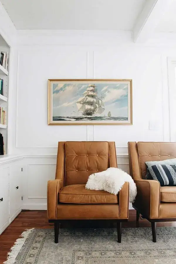 Sala branca decorada com poltronas confortáveis marrom Sala branca decorada com poltronas confortáveis marrom Foto Clark & Co. Homes