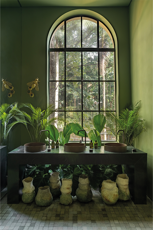 Paisagismo: Casa K Paisagismo | Vasos da coleção Jardim de Corais, criados por Alisson Silva, se destacam sobre a bancada, unindo ancestralidade, arte e consciência ambiental. As peças feitas com argila branca e técnicas sustentáveis dialogam com o paisagismo e a paleta terrosa, criando uma experiência sensorial e imersiva no ambiente da CASACOR.