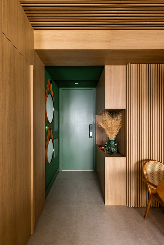 Projeto: Elisa Maretti | No hall de entrada, o verde atuou como ponto focal, e os objetos decorativos foram ajustados para o estilo dos moradores.